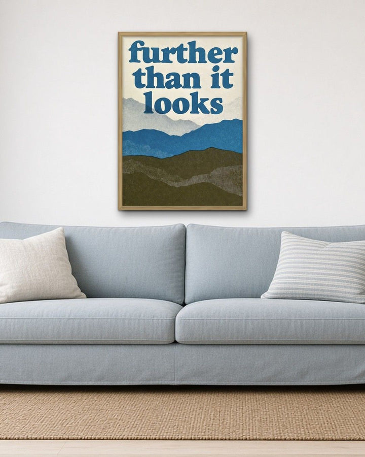 FURTHER THAN IT LOOKS framed on a wall