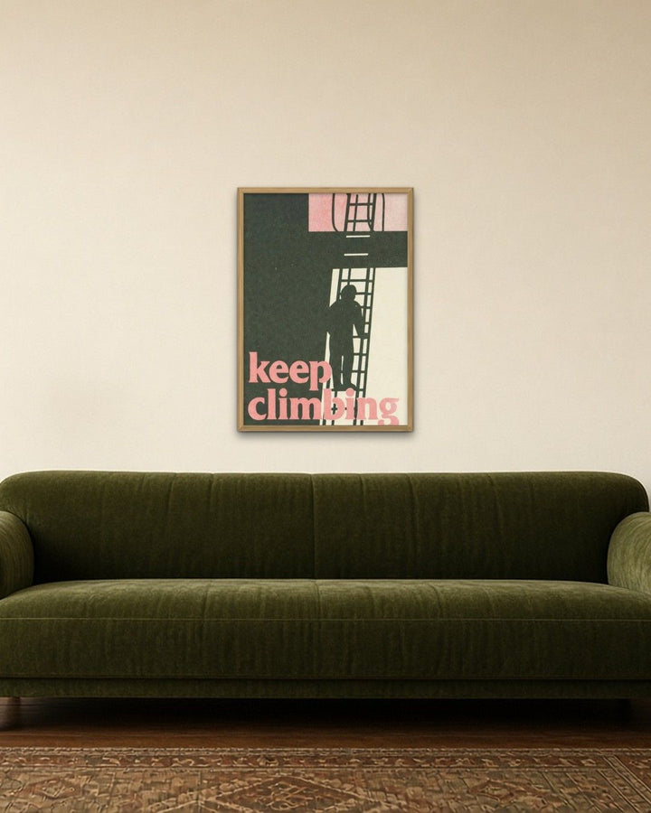 KEEP CLIMBING framed on a wall