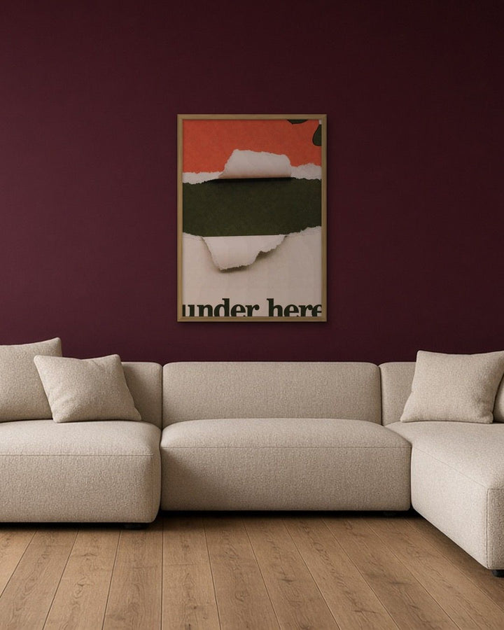 UNDER HERE framed on a wall