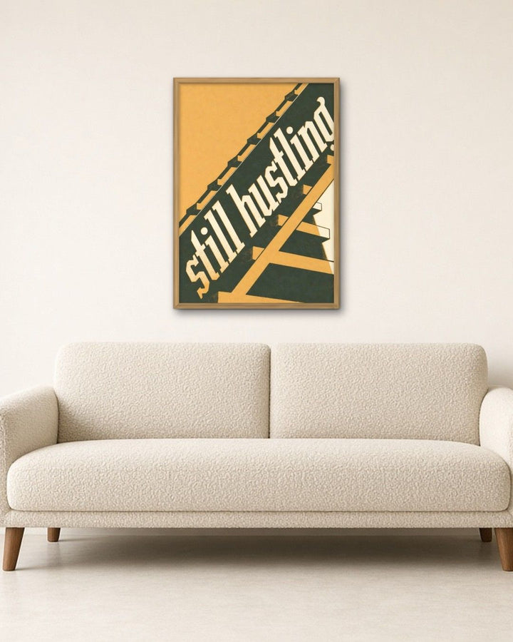 STILL HUSTLING framed on a wall